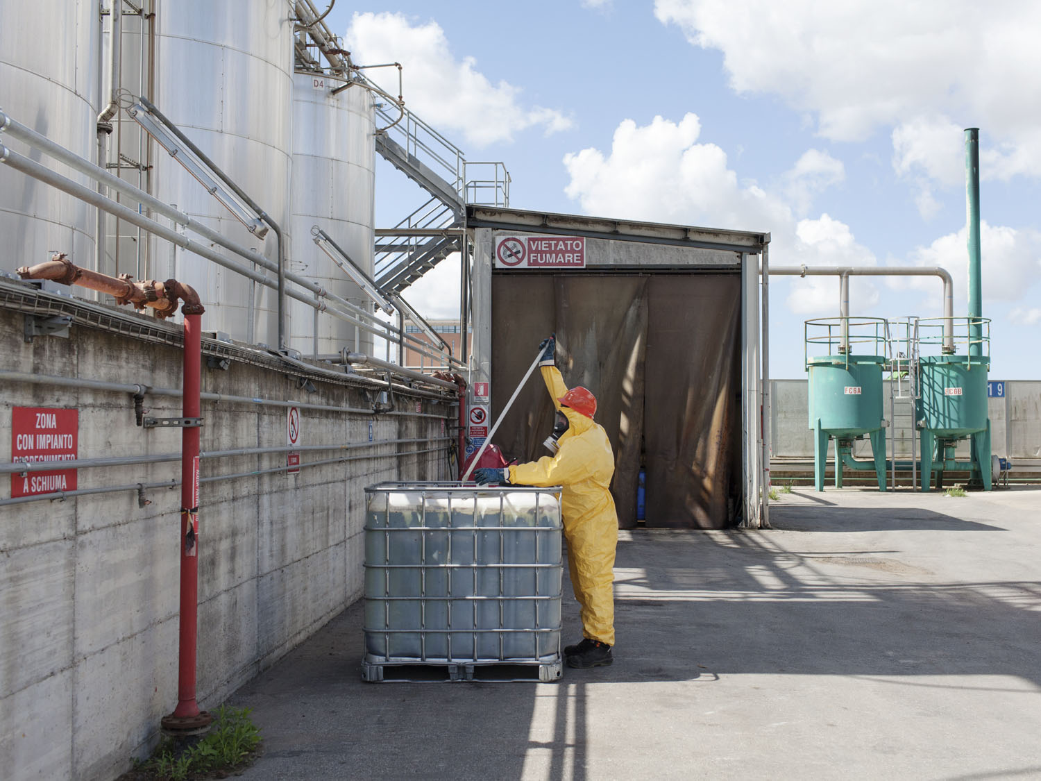 Person at work at Flammable liquid storage plant in Pisa